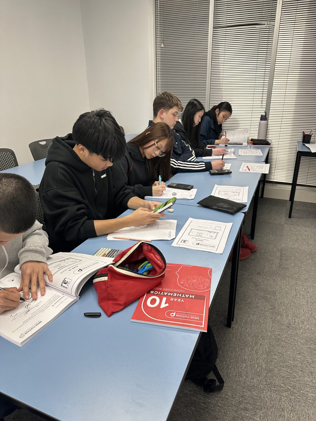 A Signal Education tutor checking in with a student during class